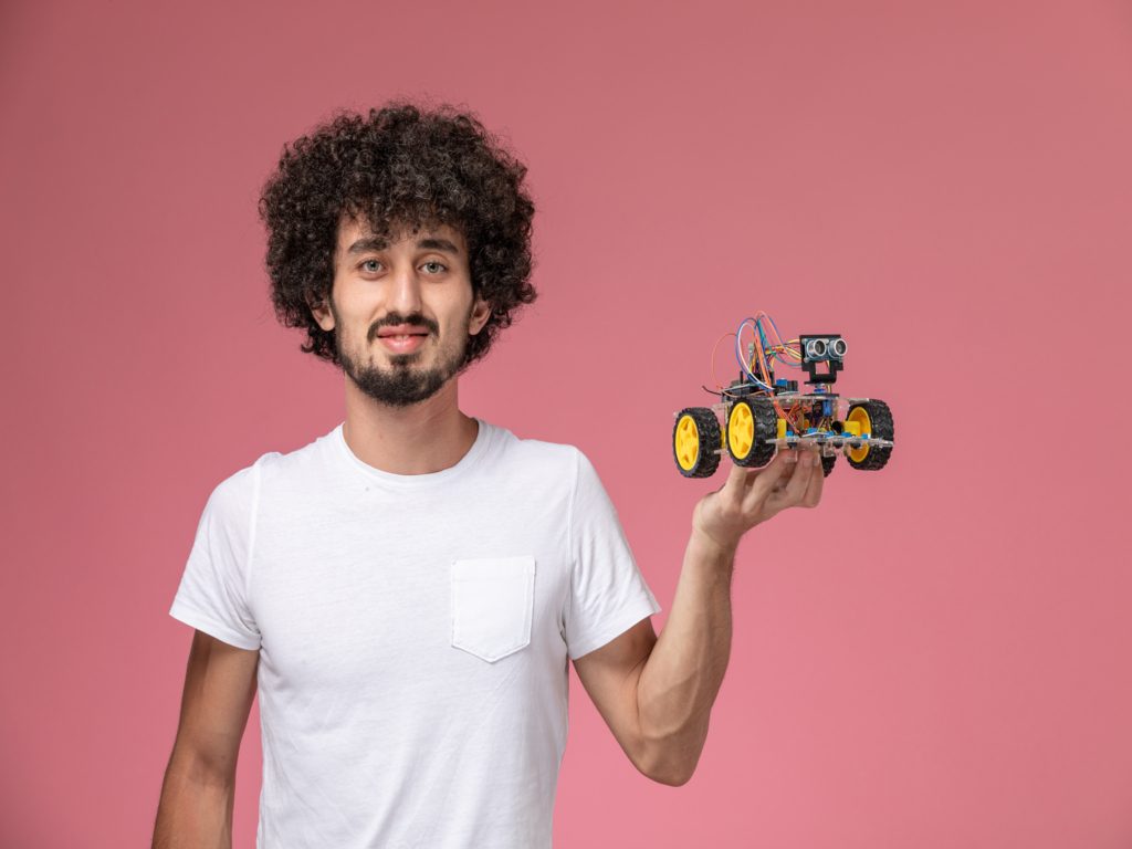 front-view-young-man-holding-his-electronic-robot (1)