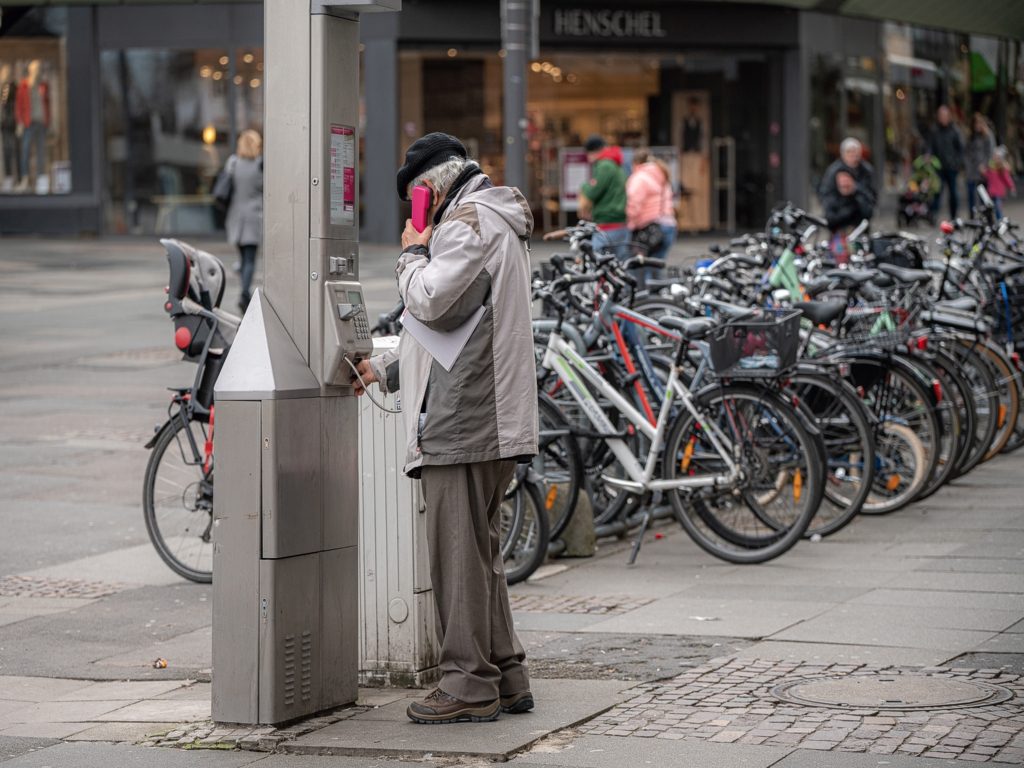 A man is calling on a kiosk